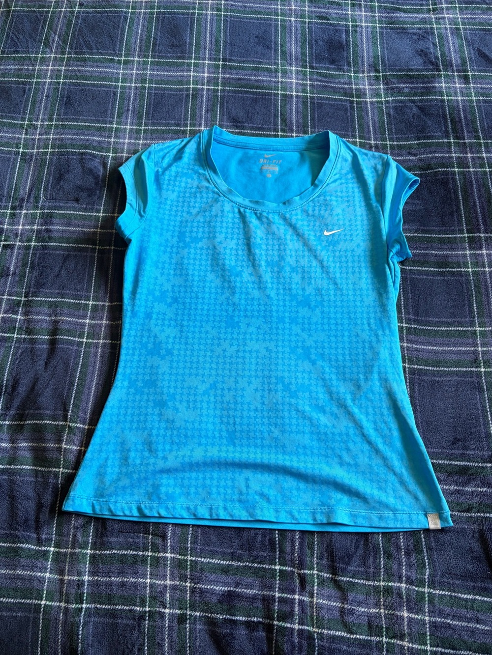 Blue Nike Dri-Fit sleeveless fitted top with subtle textured pattern. Size L.